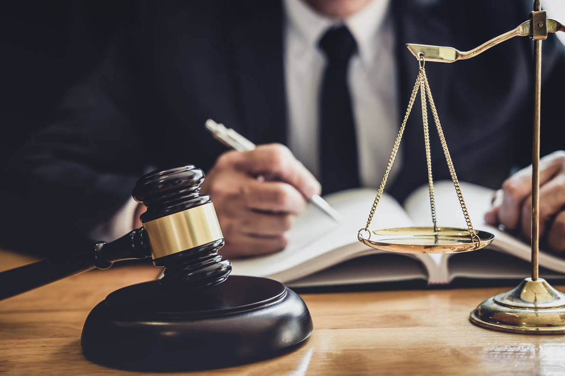 Professional Male lawyer or judge working with contract papers,